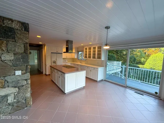 a kitchen with stainless steel appliances kitchen island granite countertop a sink and cabinets