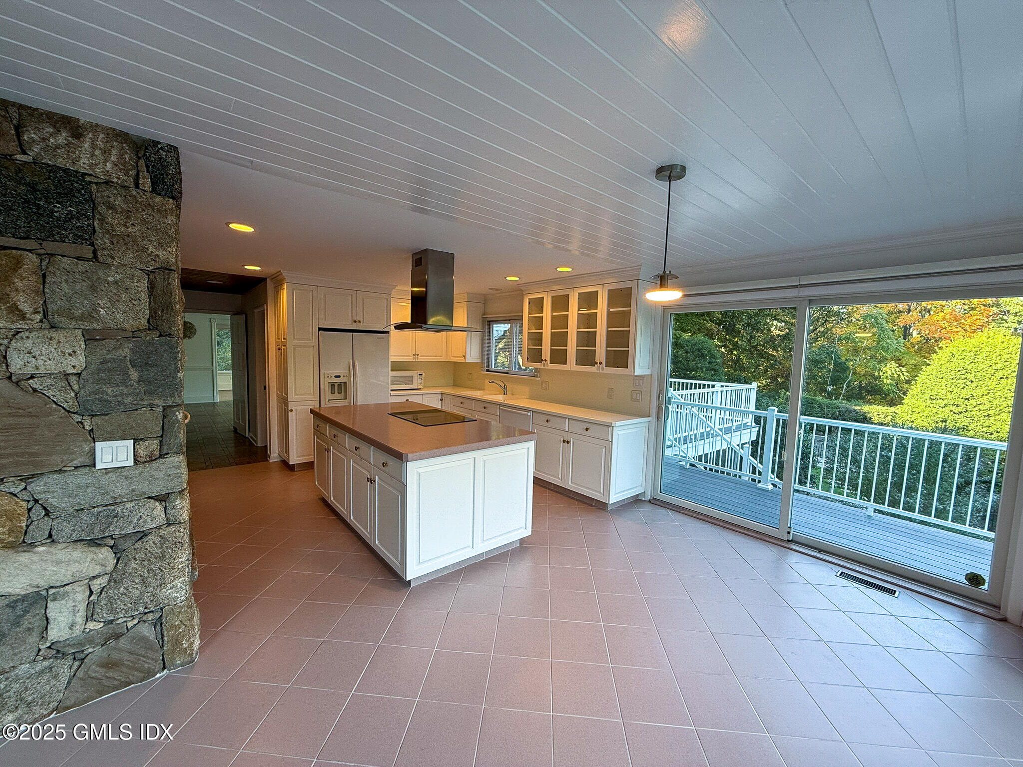 21 Harkim Road Greenwich, CT 06831 - Photo 14 of 40 a large kitchen with stainless steel appliances a large counter top a stove a chimney a sink and cabinets