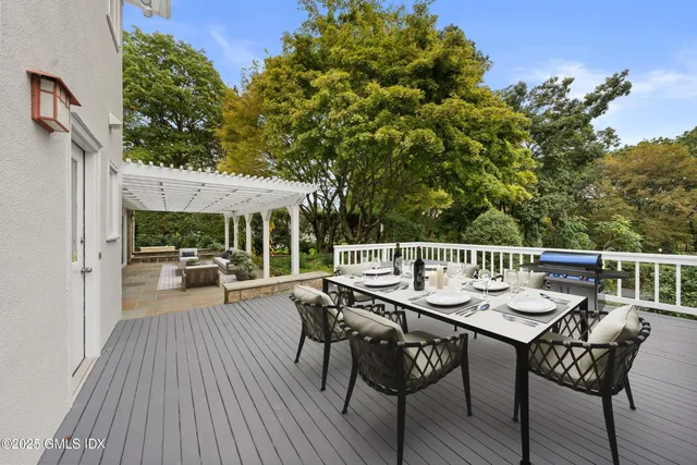 a living room with patio furniture and a floor to ceiling window