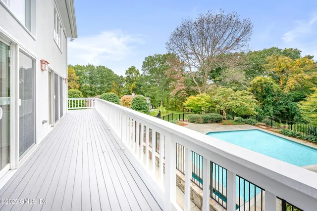 a front view of a house with a yard and potted plants