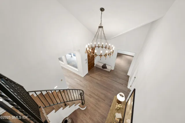 a living room with furniture a fireplace and potted plants