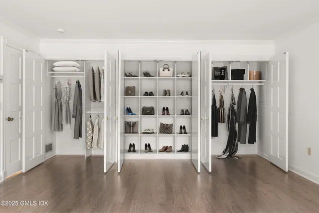 a bedroom with a bed and a television