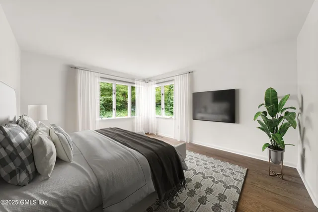 a bedroom with a large bed and a window