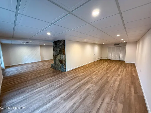 a view of house with a yard and deck area