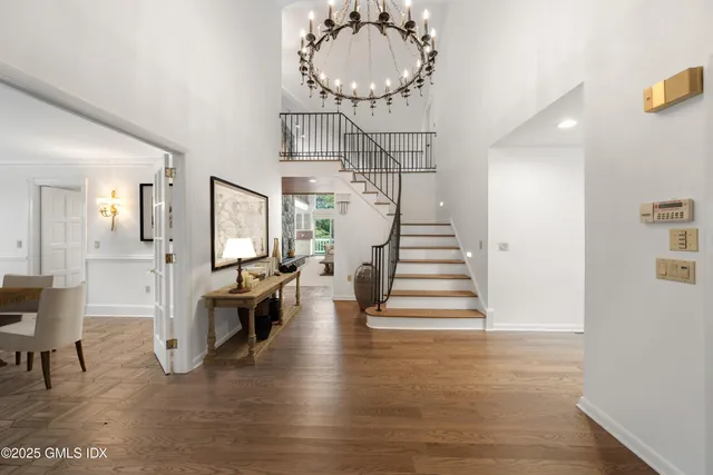 a living room with furniture a fireplace and a chandelier