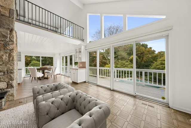 a living room with furniture large window and a fireplace