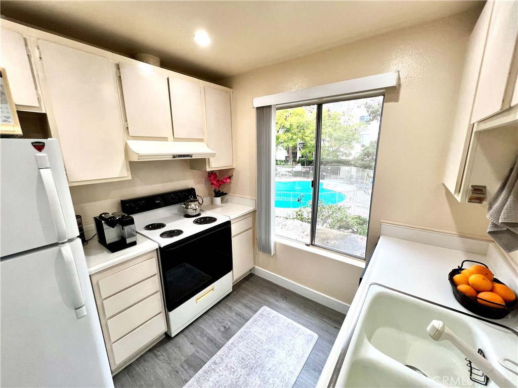 11108 Summertime Lane Culver City, CA 90230 - Photo 6 of 35 a kitchen with a sink a stove and a refrigerator