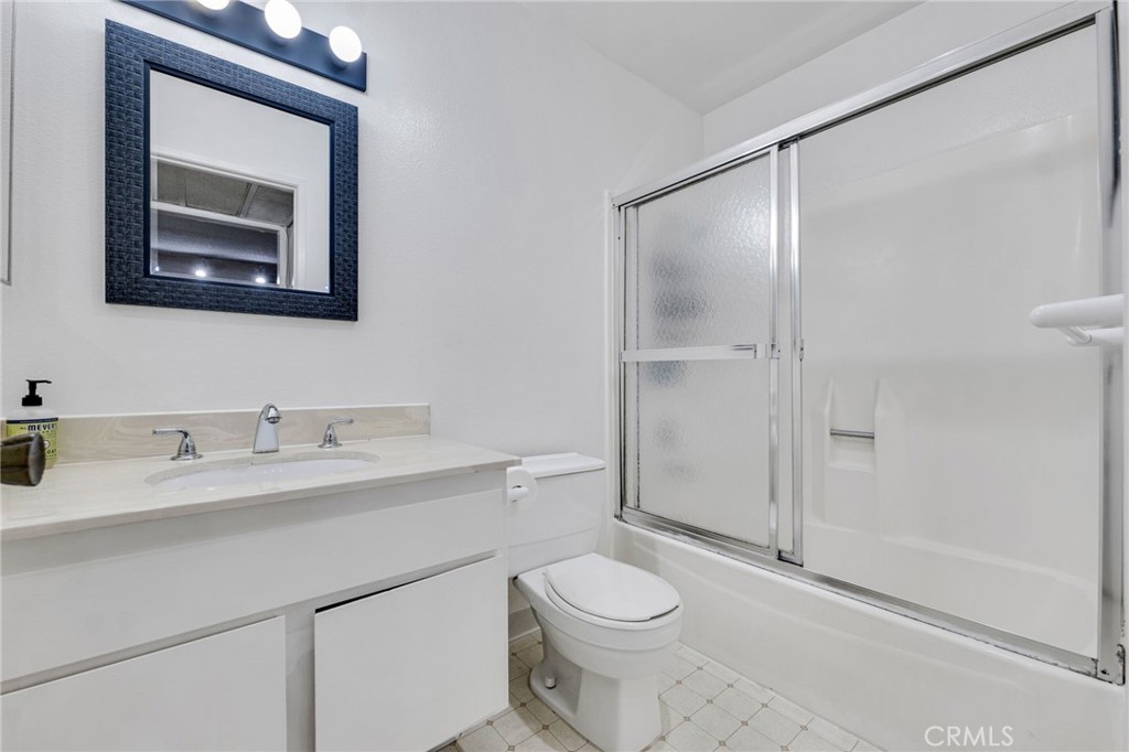 11108 Summertime Lane Culver City, CA 90230 - Photo 10 of 35 a bathroom with a toilet a sink a vanity and mirror