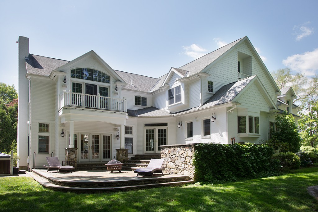73 Smith Street Wellesley, MA 02482 - Photo 9 of 9 a front view of a house with swimming pool and chairs
