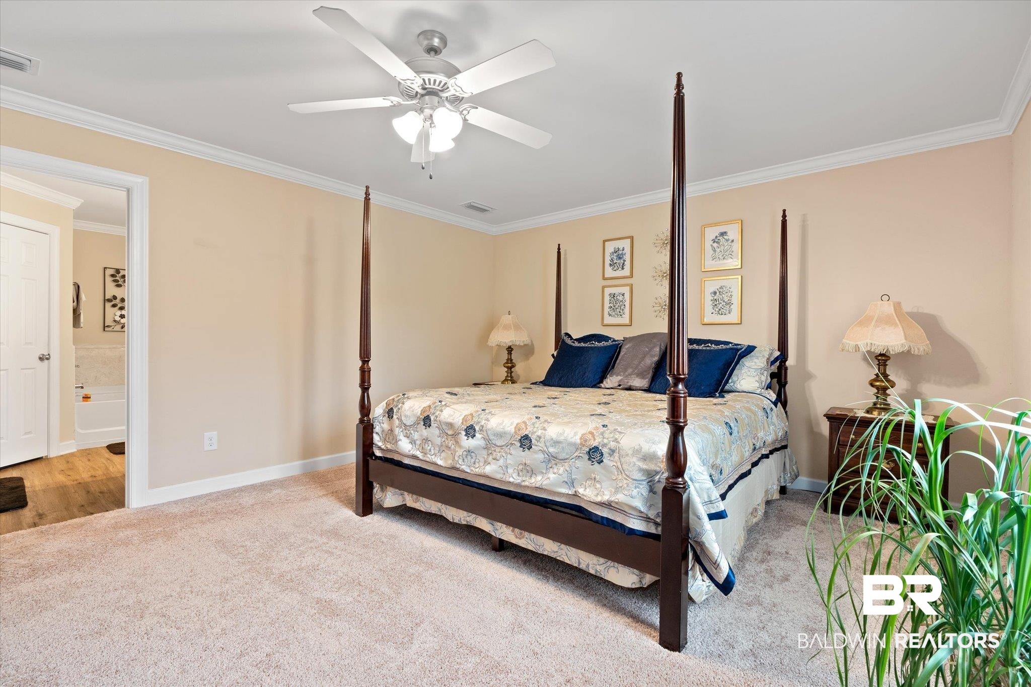 734 West Section Avenue Foley, AL 36535 - Photo 15 of 50 Bedroom featuring visible vents, ornamental molding, ensuite bathroom, carpet flooring, and baseboards