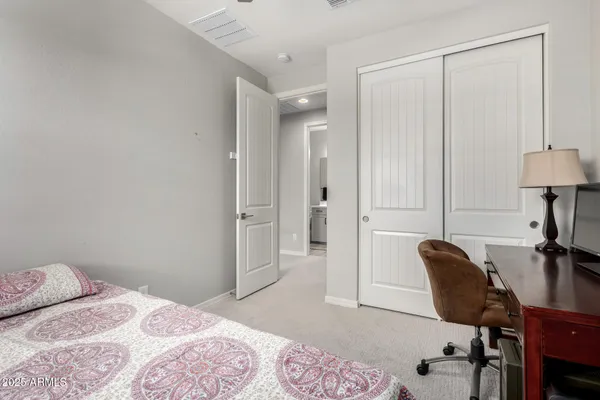 a bathroom with a sink a toilet a mirror and shower