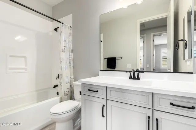 a bedroom with a bed and dresser