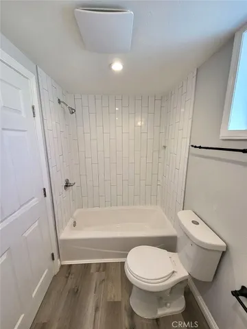 a bathroom with a toilet and a bathtub