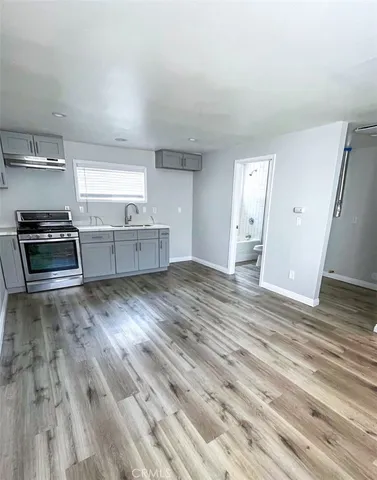 a kitchen with granite countertop a stove and cabinets