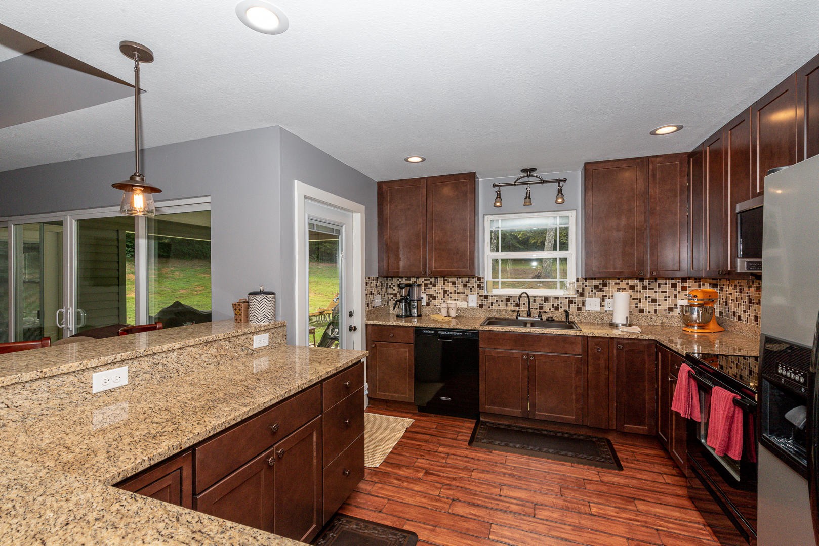 7299 Niles Ferry Road Greenback, TN 37742 - Photo 18 of 38 a kitchen with stainless steel appliances granite countertop wooden cabinets a stove and a sink