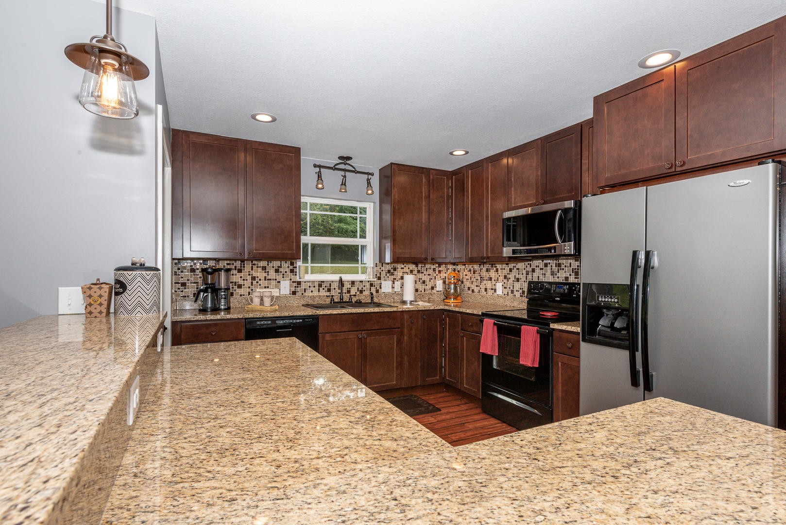 7299 Niles Ferry Road Greenback, TN 37742 - Photo 19 of 38 a kitchen with stainless steel appliances kitchen island granite countertop a refrigerator stove and sink