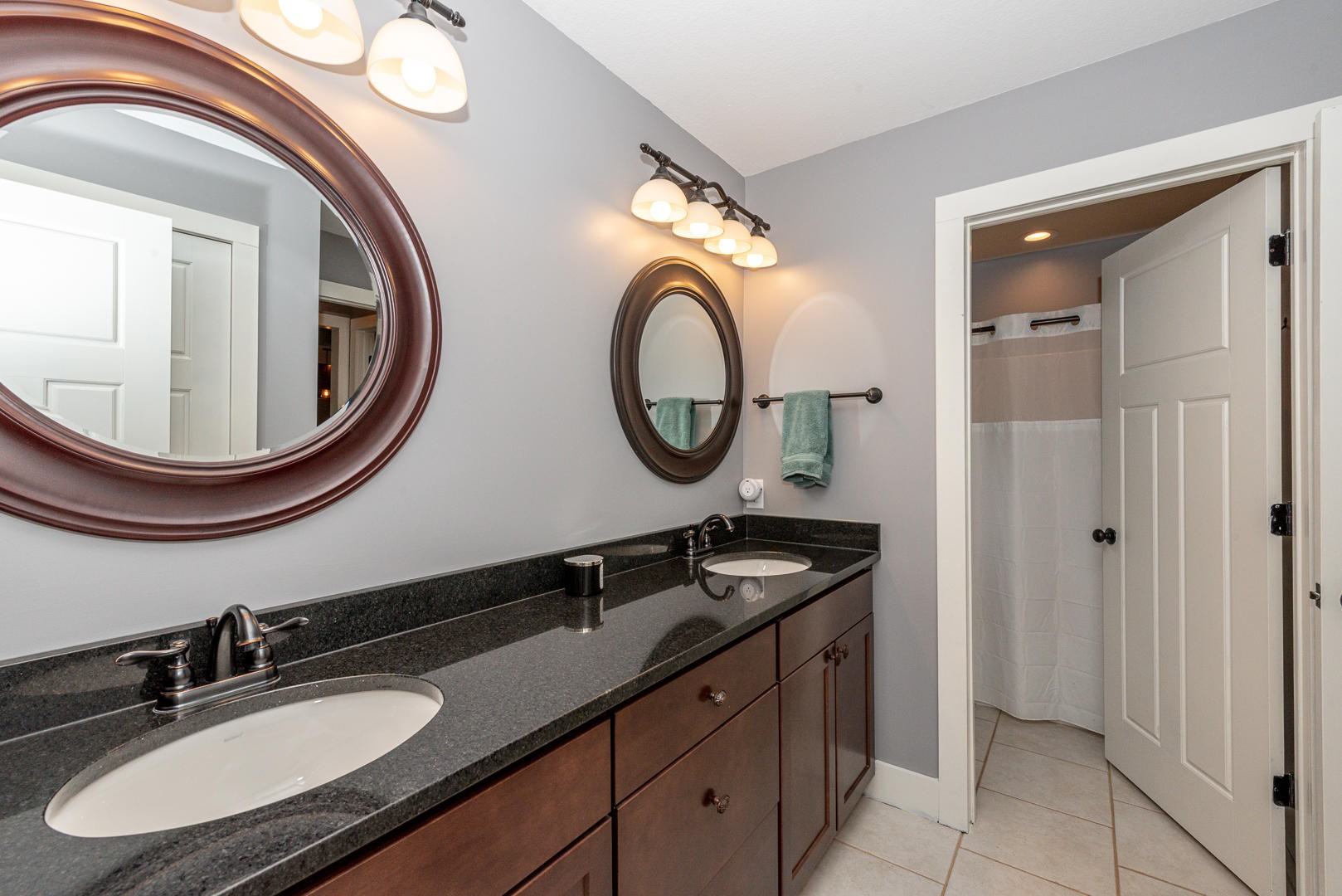 7299 Niles Ferry Road Greenback, TN 37742 - Photo 21 of 38 a bathroom with a granite countertop double vanity sink and a mirror