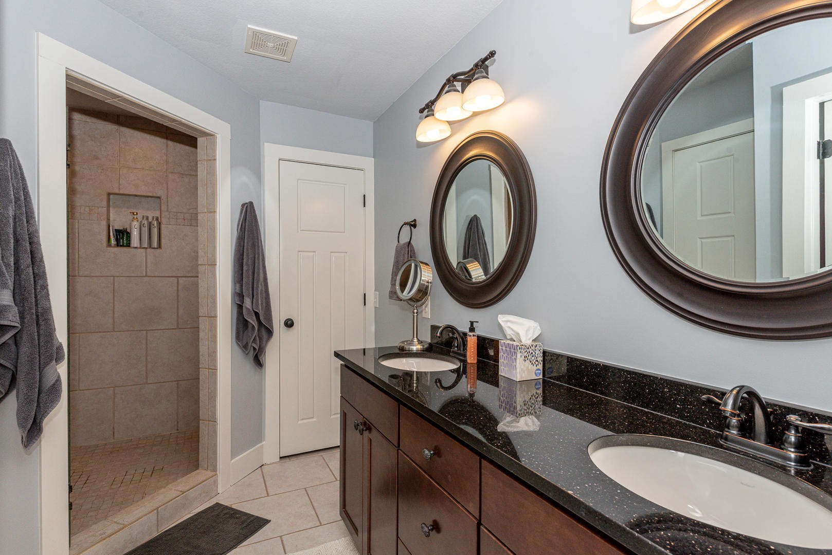 7299 Niles Ferry Road Greenback, TN 37742 - Photo 28 of 38 a bathroom with a granite countertop double vanity sink and a mirror