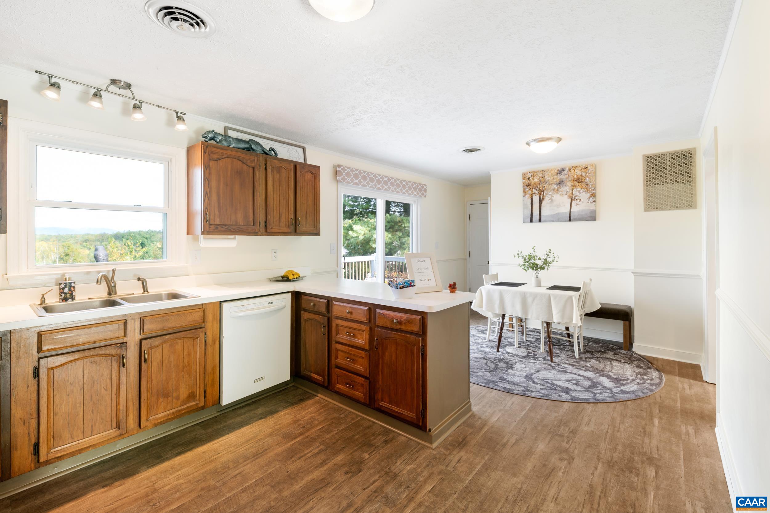 518 Jester Lane Charlottesville, VA 22911 - Photo 11 of 53 a kitchen with stainless steel appliances granite countertop a table chairs sink and cabinets