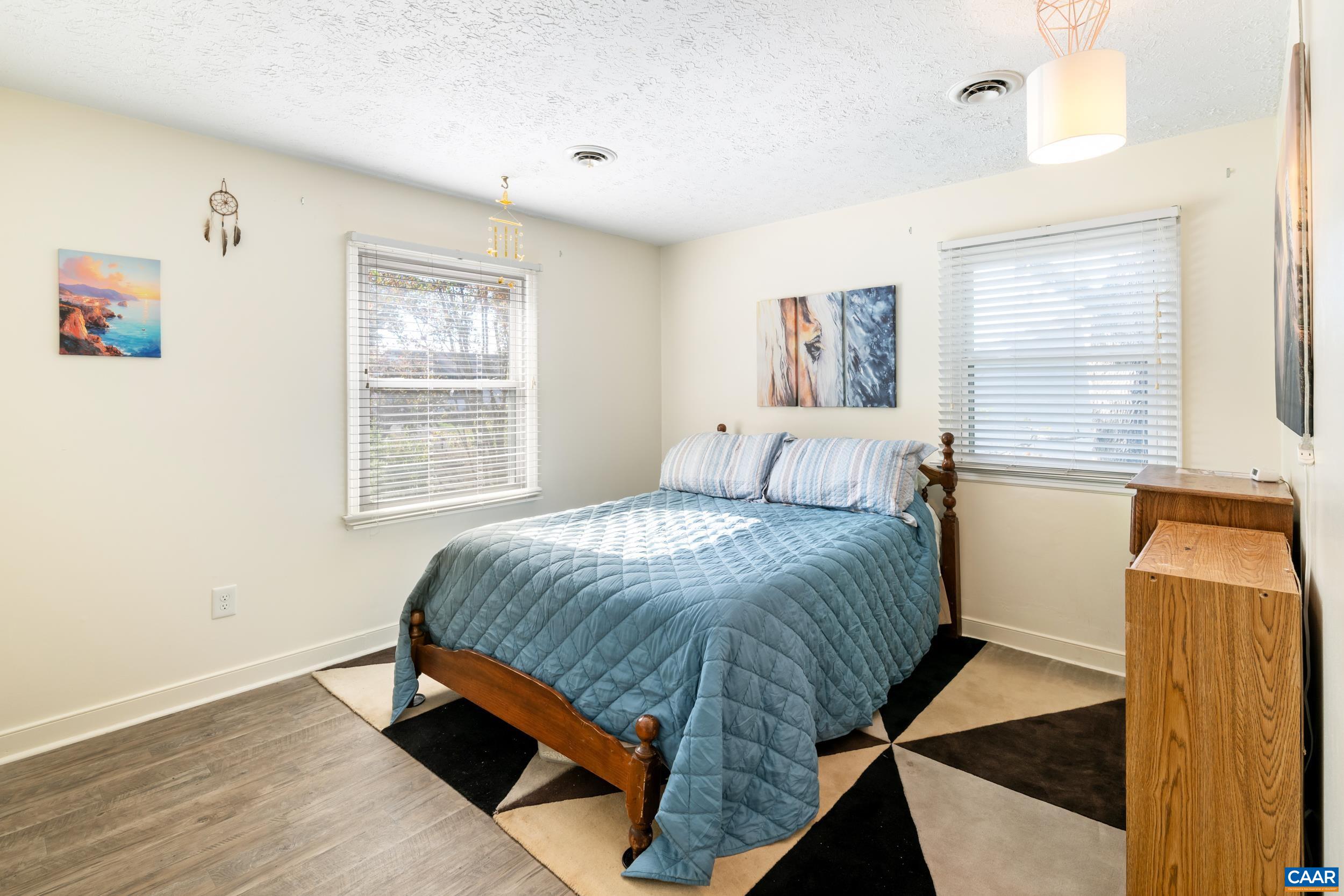 518 Jester Lane Charlottesville, VA 22911 - Photo 24 of 53 a bedroom with a bed and wooden floor