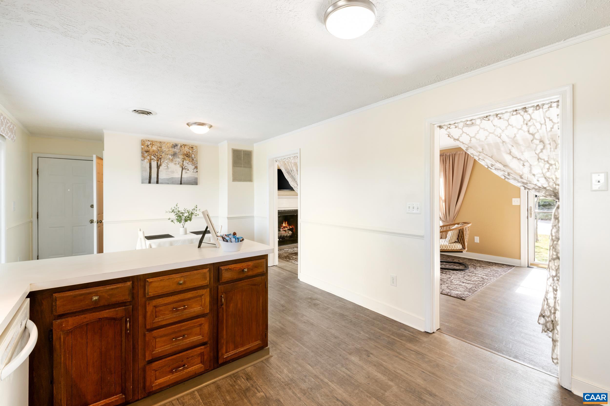 518 Jester Lane Charlottesville, VA 22911 - Photo 9 of 53 a hallway with a large mirror on a dresser with wooden floor