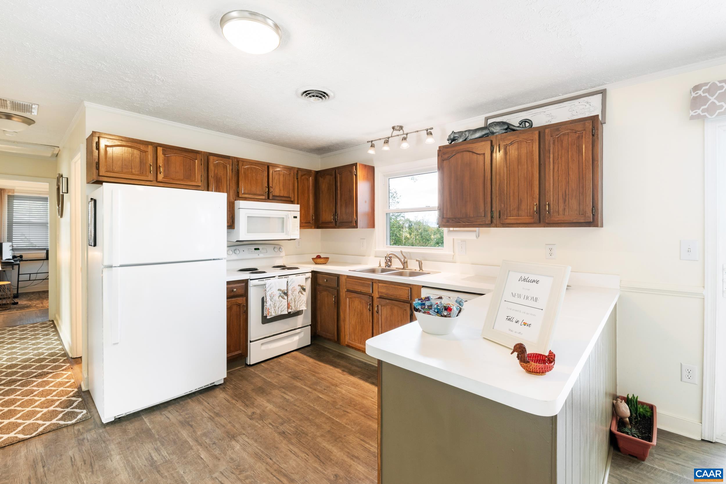 518 Jester Lane Charlottesville, VA 22911 - Photo 10 of 53 a kitchen with a sink a refrigerator a stove and wooden floor
