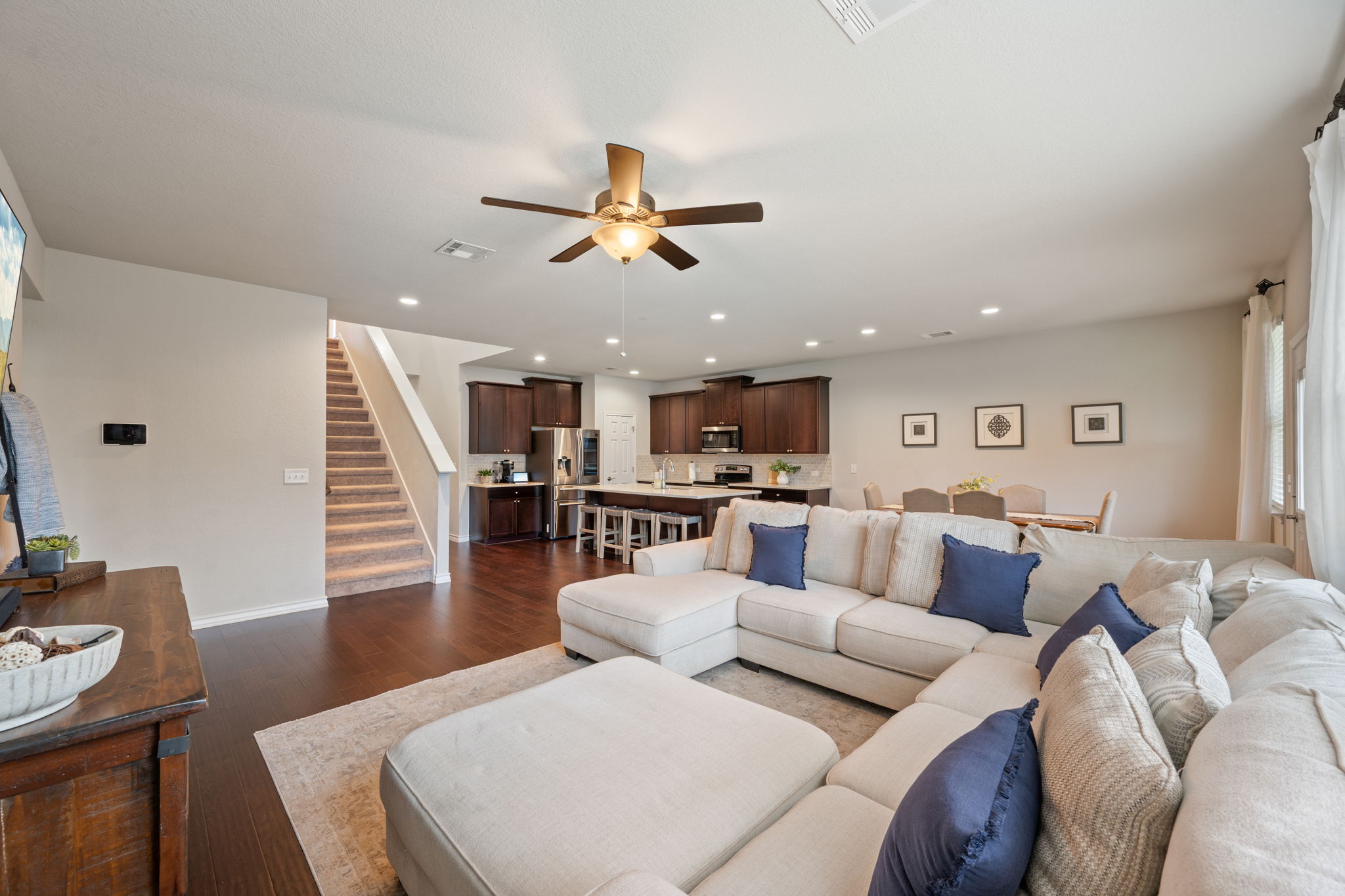 409 Limestone Road Liberty Hill, TX 78642 - Photo 11 of 35 a living room with furniture kitchen view and a wooden floor