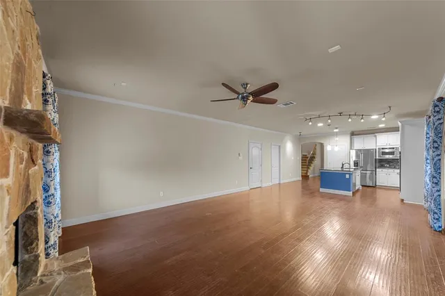 a view of a livingroom with a ceiling fan and window