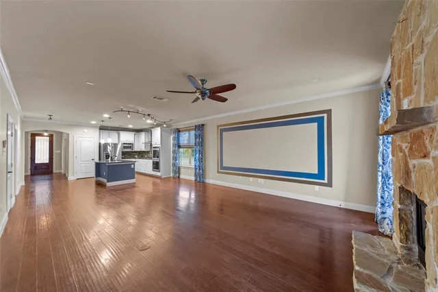 a view of a living room a window and wooden floor