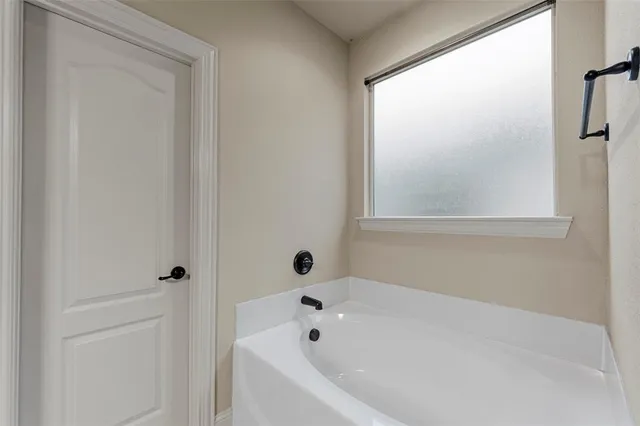 a white bath tub sitting next to a window