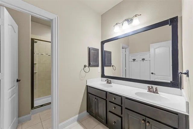 a bathroom with a double vanity sink a and mirror