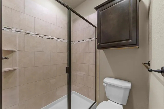 a bathroom with a toilet and a shower