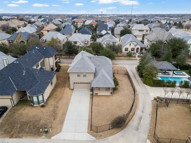 an aerial view of a house with swimming pool and patio