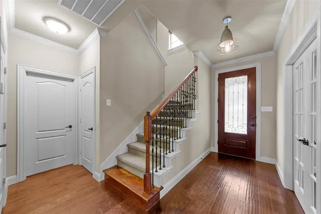 a view of entryway with stairs and wooden floor