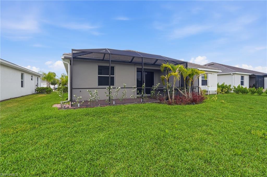 2215 Dragonfruit Way Naples, FL 34120 - Photo 37 of 38 a front view of house with yard