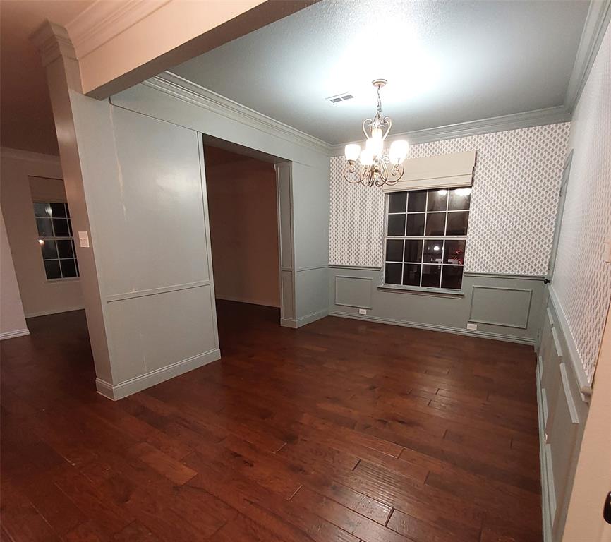1123 Hampton Drive Allen, TX 75013 - Photo 11 of 33 an empty room with wooden floor chandelier and windows