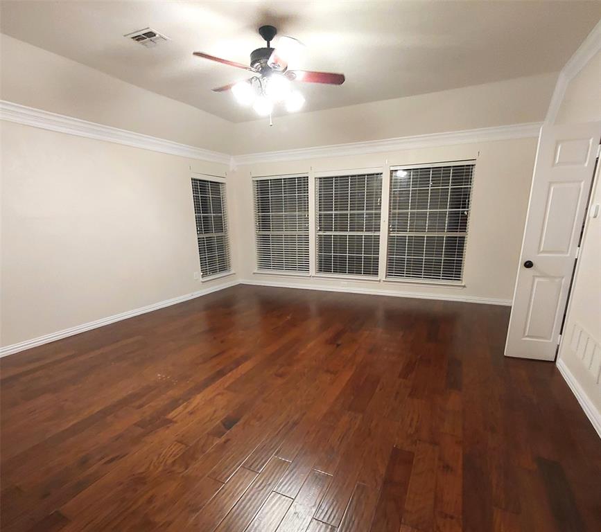1123 Hampton Drive Allen, TX 75013 - Photo 18 of 33 a view of an empty room with wooden floor and a window
