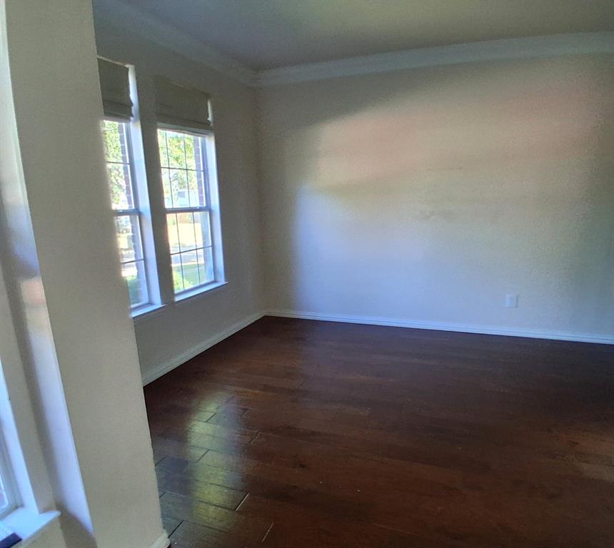 1123 Hampton Drive Allen, TX 75013 - Photo 22 of 33 an empty room with wooden floor and windows