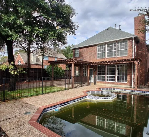 a front view of a house with a garden and yard