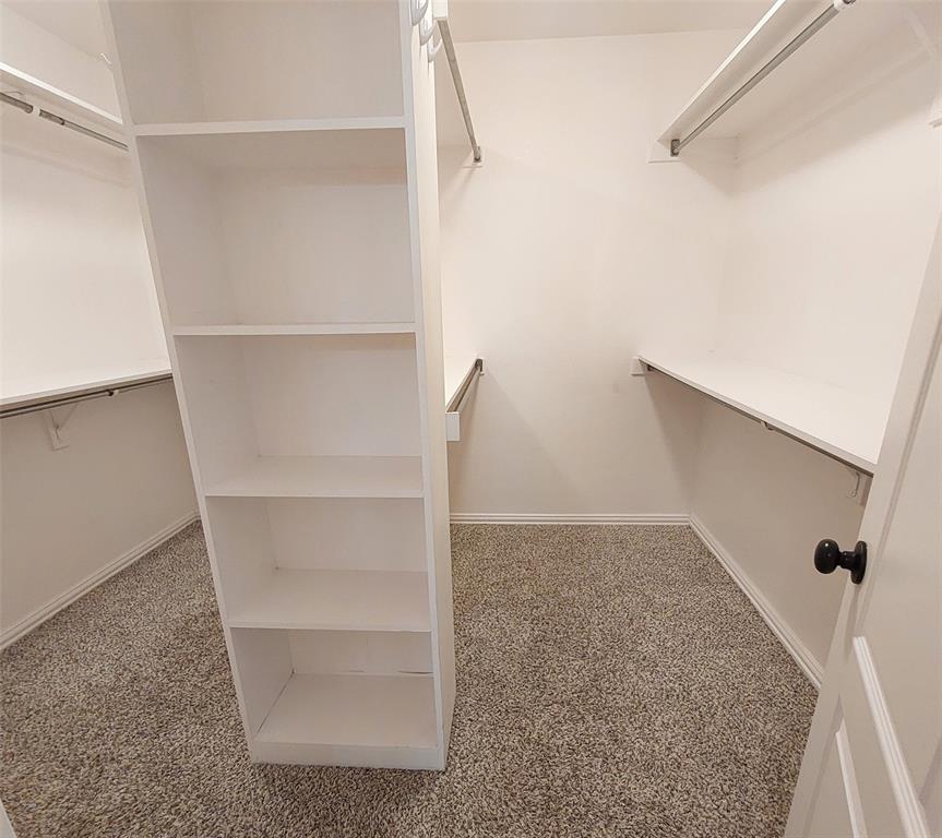 1123 Hampton Drive Allen, TX 75013 - Photo 27 of 33 a view of walk in closet with empty racks