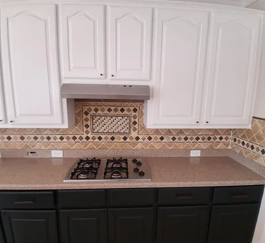 a bathroom with a sink and cabinets