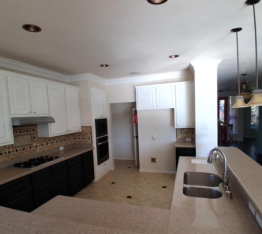 1123 Hampton Drive Allen, TX 75013 - Photo 6 of 33 a kitchen with stainless steel appliances granite countertop a refrigerator and a stove