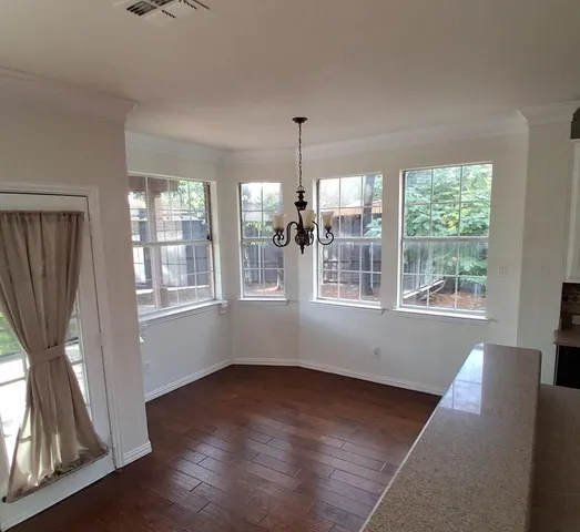 a view of wooden floor and windows in a room