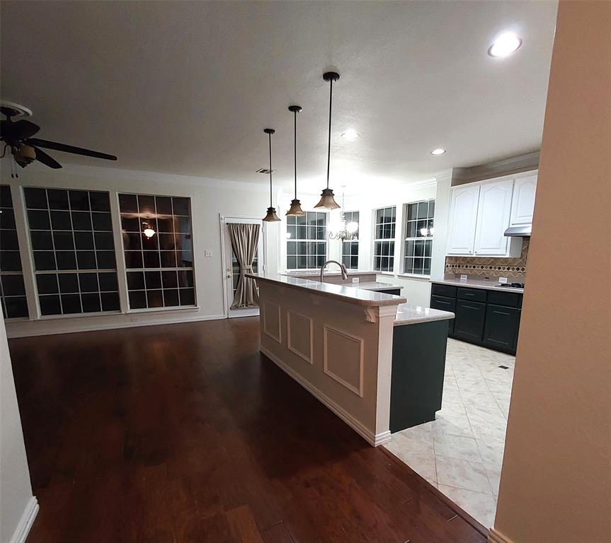 1123 Hampton Drive Allen, TX 75013 - Photo 7 of 33 a kitchen with stainless steel appliances granite countertop wooden cabinets a stove a sink and a large window