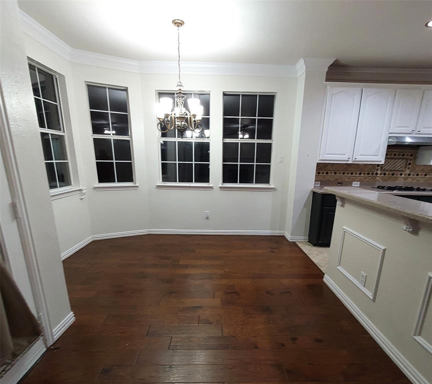 1123 Hampton Drive Allen, TX 75013 - Photo 8 of 33 a view of an empty room with a window and wooden floor