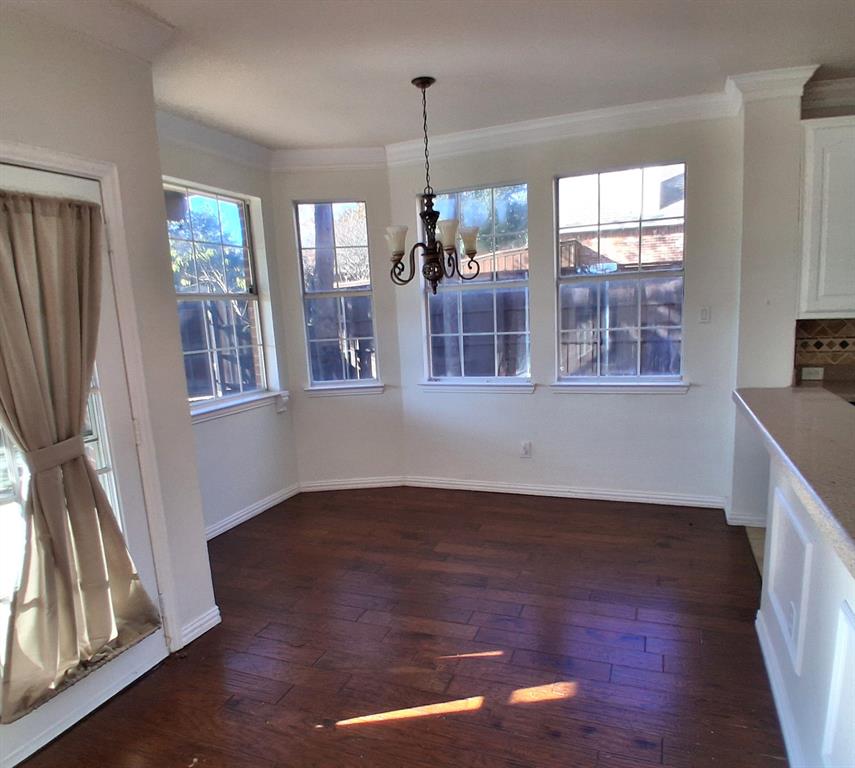 1123 Hampton Drive Allen, TX 75013 - Photo 9 of 33 an empty room with wooden floor and windows