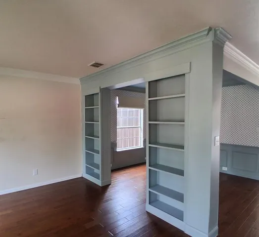 a view of walk in closet with empty racks