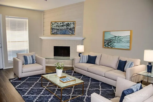 a living room with furniture a rug and a window