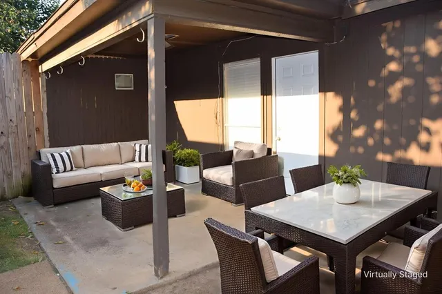 a outdoor space with patio couch and a potted plant