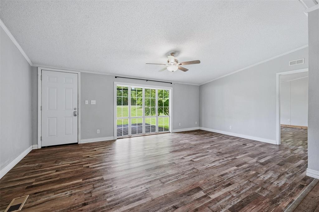 150 Gilbreath Road Sadler, TX 76264 - Photo 7 of 34 a view of an empty room with wooden floor and a window